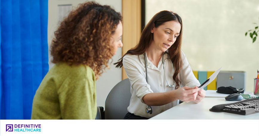 A patient and healthcare professional review test results while sitting at a desk together